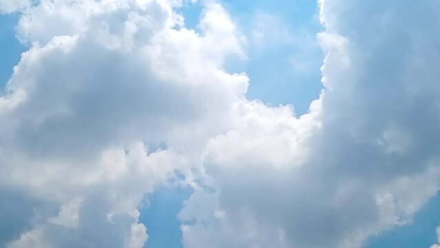 Blue sky white clouds. Puffy fluffy white clouds. Cumulus cloud cloudscape time lapse. Summer blue sky time lapse. Nature weather blue sky. White clouds background. Cloudy time lapse , video loop