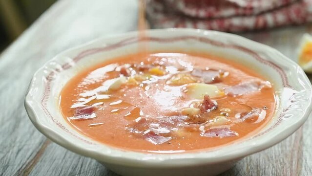 Eating the freshly prepared cold tomato Spanish soup.
