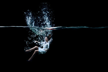 Young businesswoman swimming underwater . Mixed media - obrazy, fototapety, plakaty