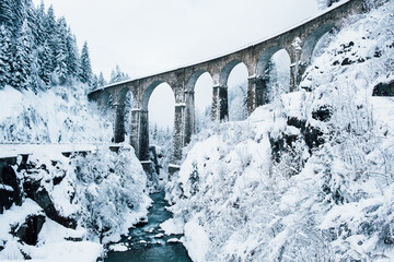 Mountain landscape with Sainte Marie bridge covered with snow in Les Houches, Chamonix valley,...