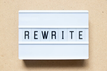 Lightbox with word rewrite on wood background