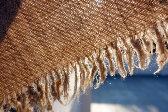A close up shot of khaddar or khadi, cotton fabric cloth in detail against sunlight. Khaddar is a type of plain cotton cloth produced in India.