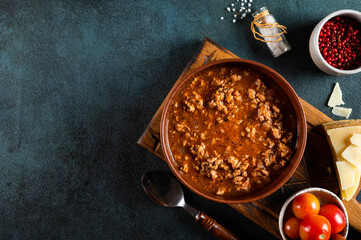 classic italian bolognese sauce with ingredients on blue background. Bolognese sauce top view. culinary background with space for text. Pasta bolognese. Italian lasagna