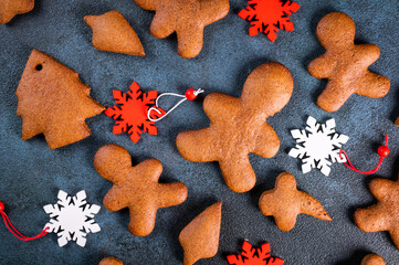 Homemade gingerbread cookies on dark background. Christmas composition, new year background. Christmas dessert. New Year flatlay.