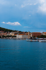 beautiful town a promenade with palm treesm, a church and boats in Split, Croatia