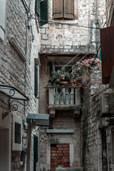 traditional, mystical street in Trogir, Croatia with flowers and balconies in Trogir, Croatia