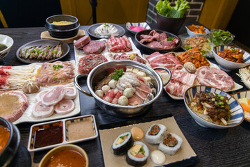 Korean traditional style assorted bbq grilled set, fresh Asian side dish vegetables, and shabu-shabu