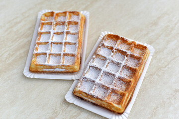 Two Belgian waffles in a restaurant