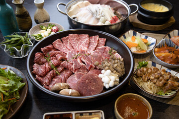 Korean traditional style assorted bbq grilled set, fresh Asian side dish vegetables, and shabu-shabu