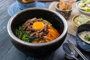 Korean traditional food Bibimbap in a hot stone pot