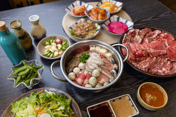 Korean traditional style assorted bbq grilled set, fresh Asian side dish vegetables, and shabu-shabu