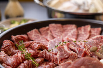 Korean traditional style assorted bbq grilled set, fresh Asian side dish vegetables, and shabu-shabu