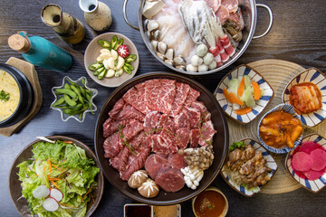 Korean traditional style assorted bbq grilled set, fresh Asian side dish vegetables, and shabu-shabu