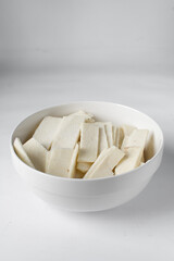 Raw yam in a white bowl, slices of raw yam, fried yam slices, nigerian white yam