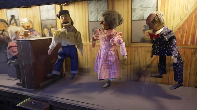 This video shows an automaton vintage puppet coin operated machine with dancing puppets in a victorian scene.