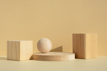 Wooden scenes of different geometric shapes on a beige background. Premium podium for advertising...