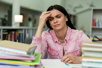 Caucasian student women reading books in library at university. Young undergraduate girl feeling stressed and have problem while study hard