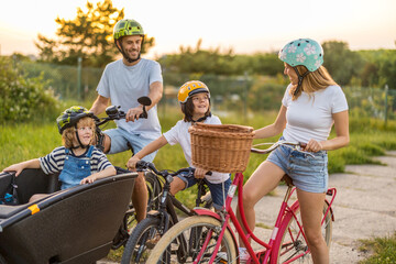 Happy family cycling together in the countryside
