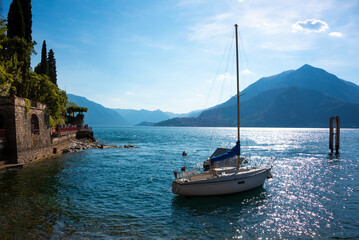 Beautiful panorama of lake Como in summer, boat next to coast