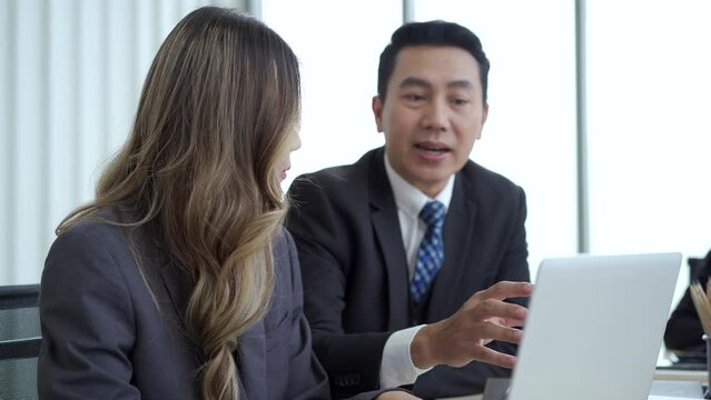 Senior general manager making a discussion or talking to his female secretary.