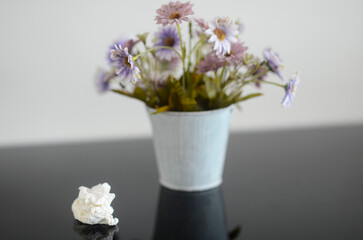 Used tissues on a table with flowers