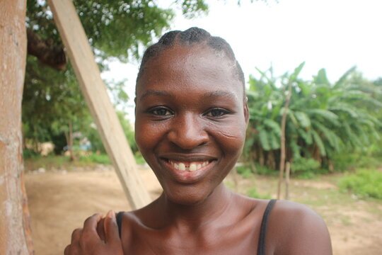 Close up of black woman with natural skin and hair and tooth gap