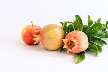 Rosh hashanah (jewish New Year holiday) concept. Pomegranate and apple traditional symbol over white background