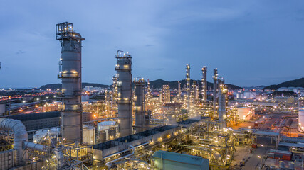 Oil and gas refinery plant form industry zone at night, Aerial view oil and gas Industrial...