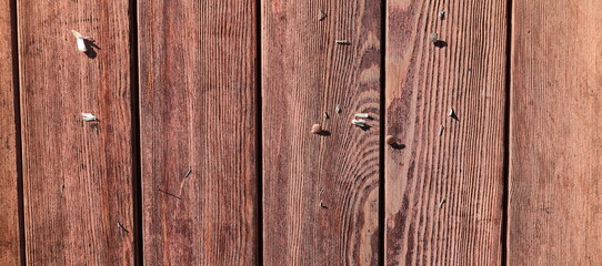 an empty bulletin board made of old wooden boards 