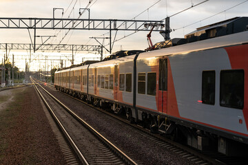 Express train moves from empty station at sunset light. Technology allows people to travel and plan journey. High-speed train starts journey reaching new destination to pick up and drop off passengers