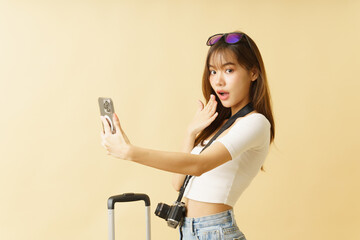 Asian beautiful woman traveler raised smartphone while looking surprisingly.