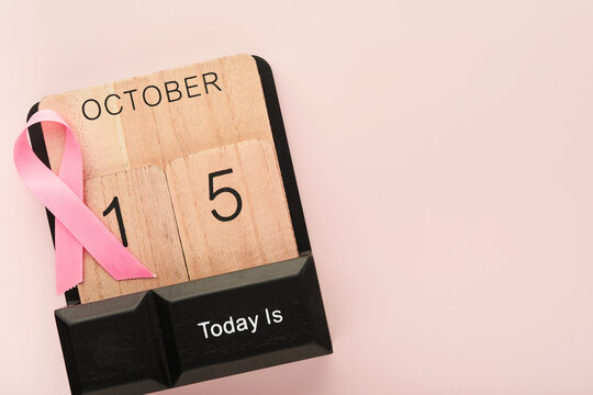 Pink Breast Cancer Awareness Ribbon. Wooden calendar with pink ribbons on backgrounds. Breast cancer awareness and October Pink day, world cancer day. Top view. Mock up.