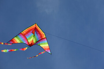 Kite with rainbow colors flying in the sky symbol of hope joy brotherhood