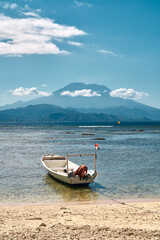 Boat on the shore with a view of a volcano