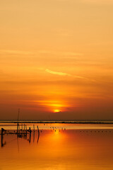 Fototapeta na wymiar Sun setting over a calm sea