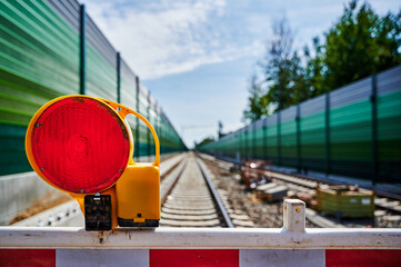 Warning light on a barrier in front of the construction site for a new railway line.
