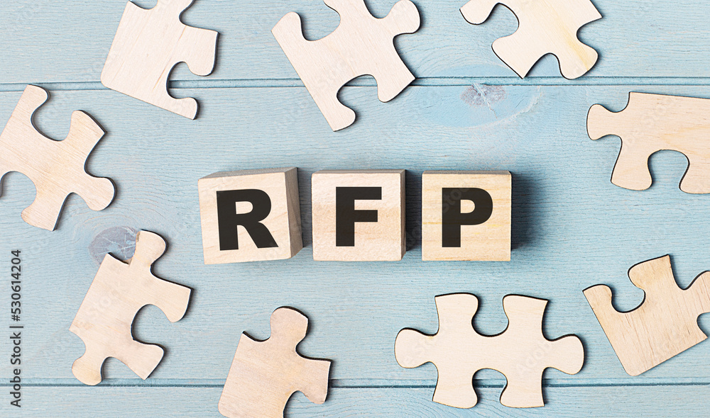 Poster blank puzzles and wooden cubes with the text rfp request for proposal lie on a light blue background
