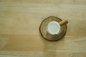 Fresh milk in a shot glass for ingredients to making drinks put on wood table