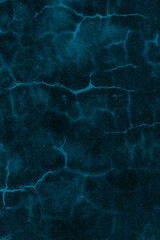 Dark blue concrete plaster wall with crack lines for texture background