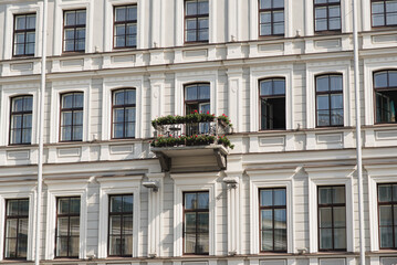 Fototapeta premium View of the facade of the house with windows and a balcony.
