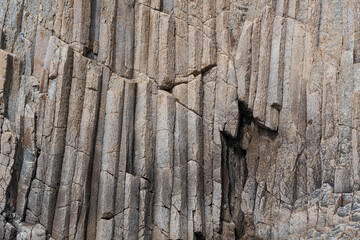 surface of a rock wall formed by columnar basalt