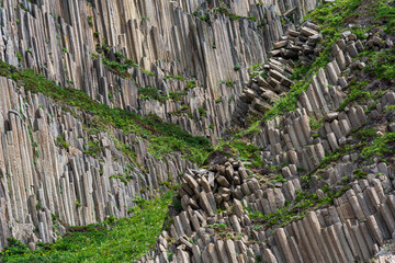 landscape with columnar basalt rocks forming a natural geometric pattern