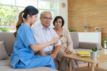 Young female nurse doctor caregiver holding tablet explaining prescription prescribing drug to elderly patient at nursing home. Record check up information. Healthcare pharmacy and insurance service