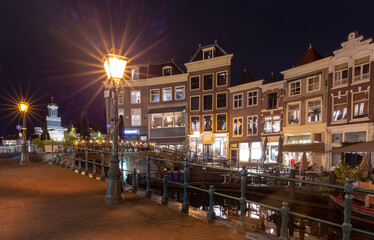 Beautiful old houses on the city embankment of Leiden at sunset.