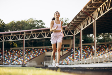Woman running on the stadium running track