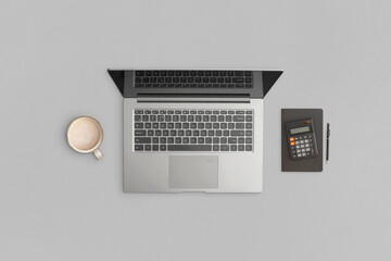 Laptop, calculator, notebook, pen on gray background. Financial development, Banking Account, Statistics