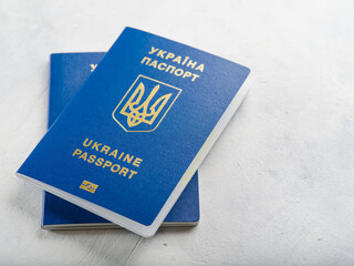 Two Ukrainian biometric passports on a light background. Close-up. Minimalism. There are no people in the photo. Business, tourism, freedom. independence, emigration.
