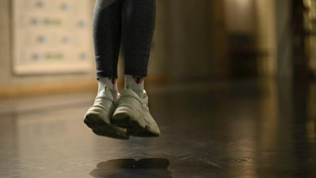 beautiful slim athletic girl jumping rope in the gym in slow mo. beautiful cinematic frame for advertising