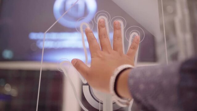 Business woman using a biometric decoder scans data from her hands
