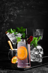 Lemonade with rose syrup and orange. On a black background. Bar menu.